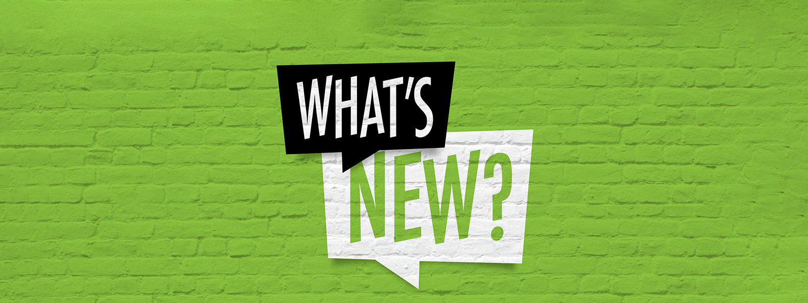 grüne Backsteinwand, Worte "What's new" in Sprechblasen
